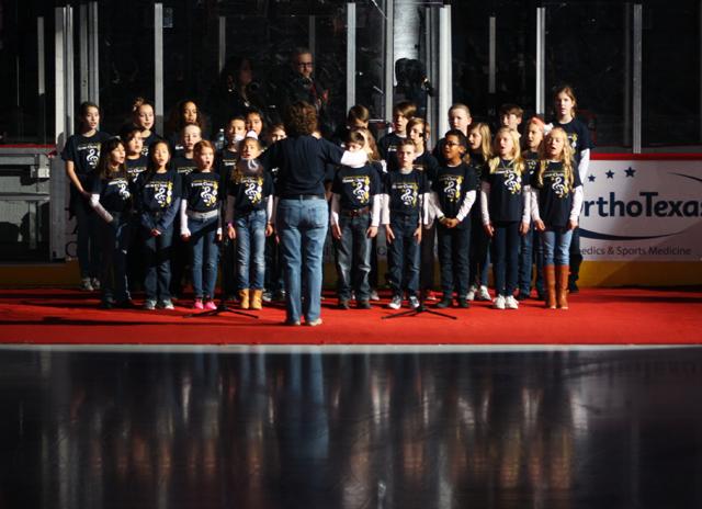 Lower School Honor Choir performs the National Anthem at the Allen Americans game