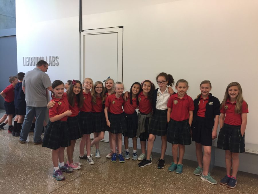 4th grade girls pause for a picture while on a field trip at the Perot Museum. 
