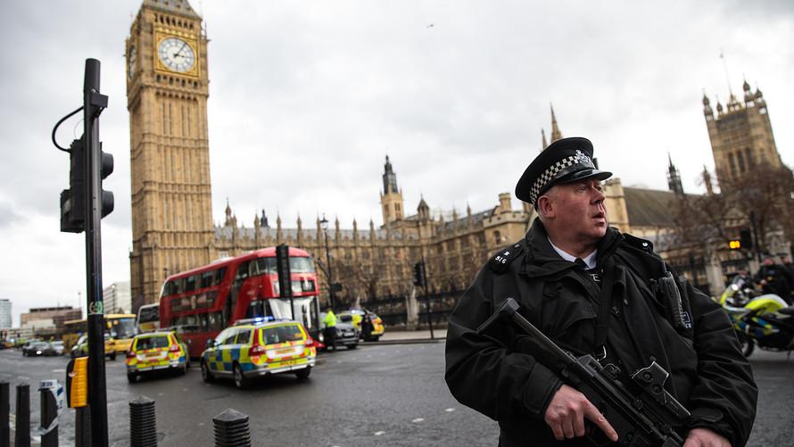 A British Law Enforcement personnel stands watch following the attack.