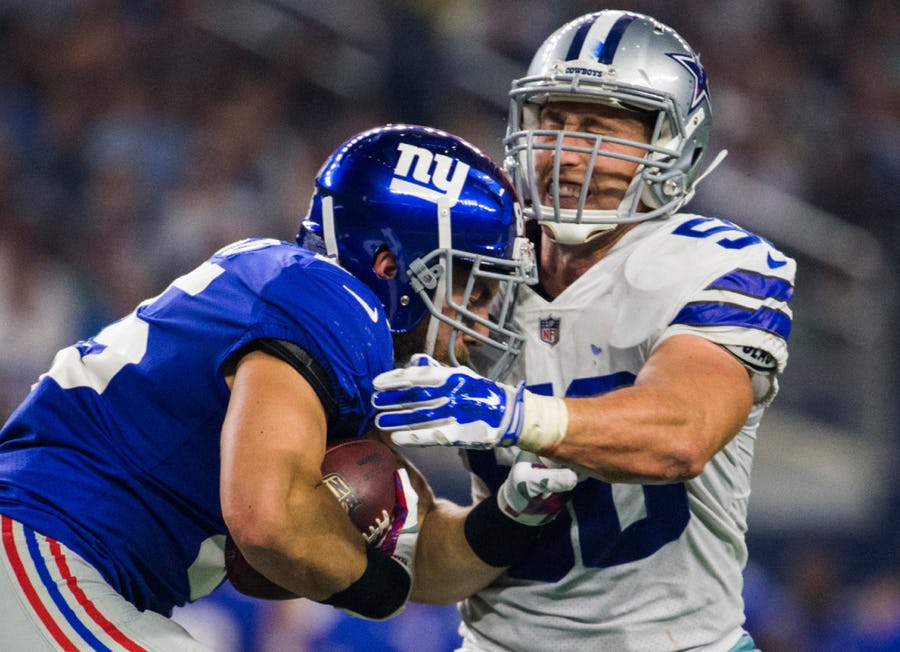 Sean Lee goes in for a tackle during the third quarter against the tight end, Rhett Ellison.