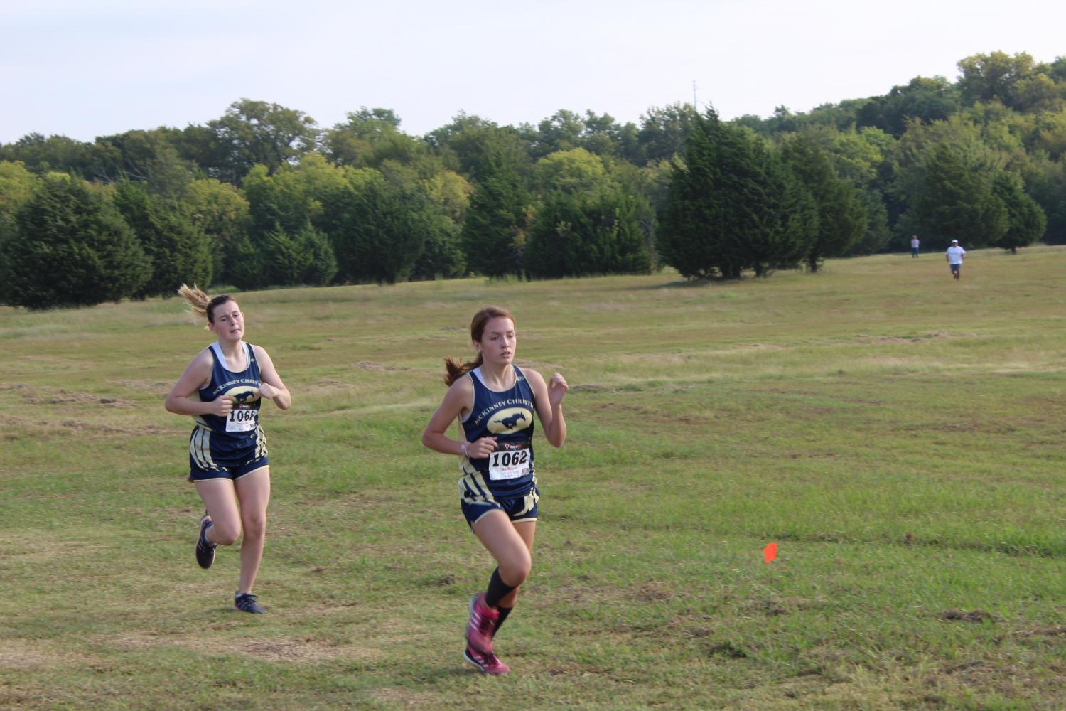 Junior Kara Vita and Sophomore Brooke Fillebrown keep a steady pace during the race to keep their place.