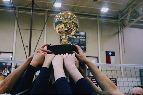 The girls celebrate their win by showing off their Regionals trophy.