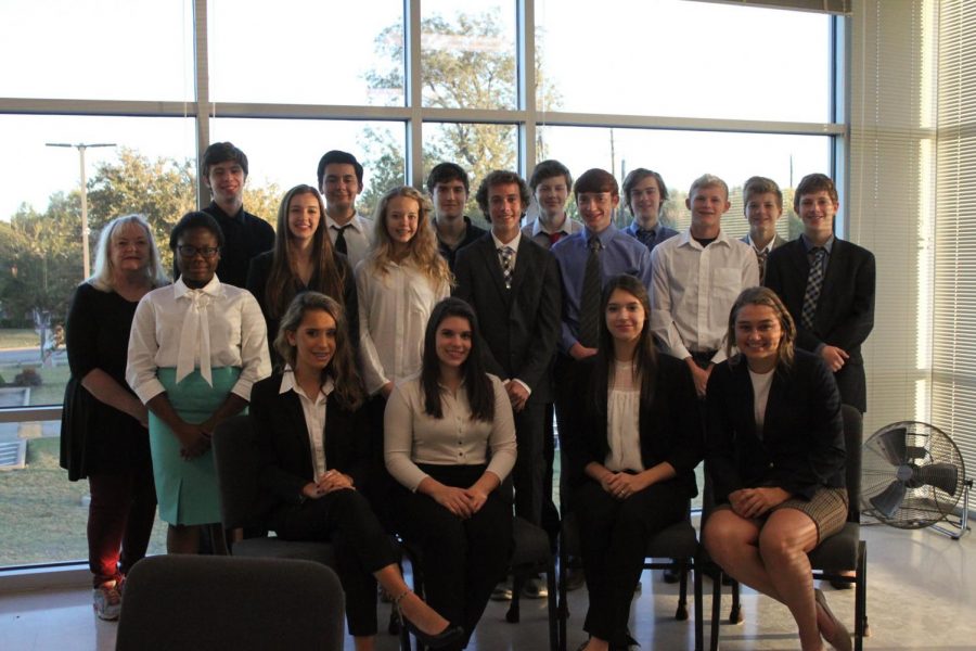 Upper School Debate team poses for a picture at a tournament. 