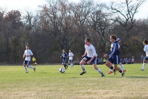 Caleb Bryant, 10th, guards the ball from an upcoming opponent.