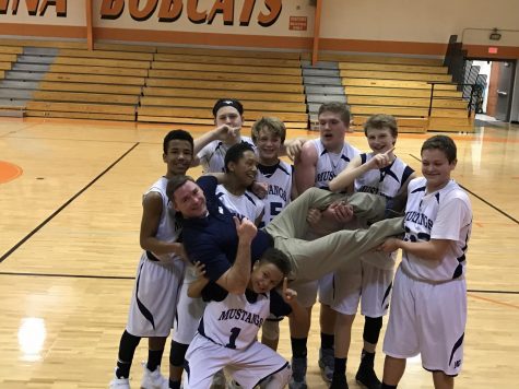 MS D1 Boys Basketball celebrates another win with Coach Wysong.