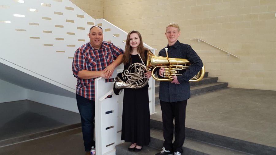 Band Director Ken Snow and Middle Schoolers Sarah Dahl and Tyler Carpenter take a picture after their performance 