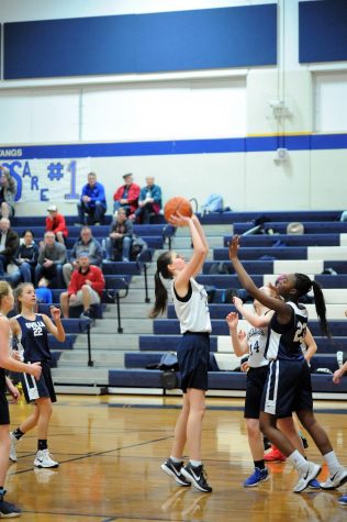 Eighth Grader, Karlene Shelton goes up to take a shot, resulting with a point for the Mustangs.
