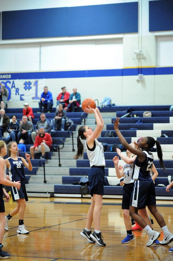 Eighth Grader, Karlene Shelton goes up to take a shot, resulting with a point for the Mustangs. 
