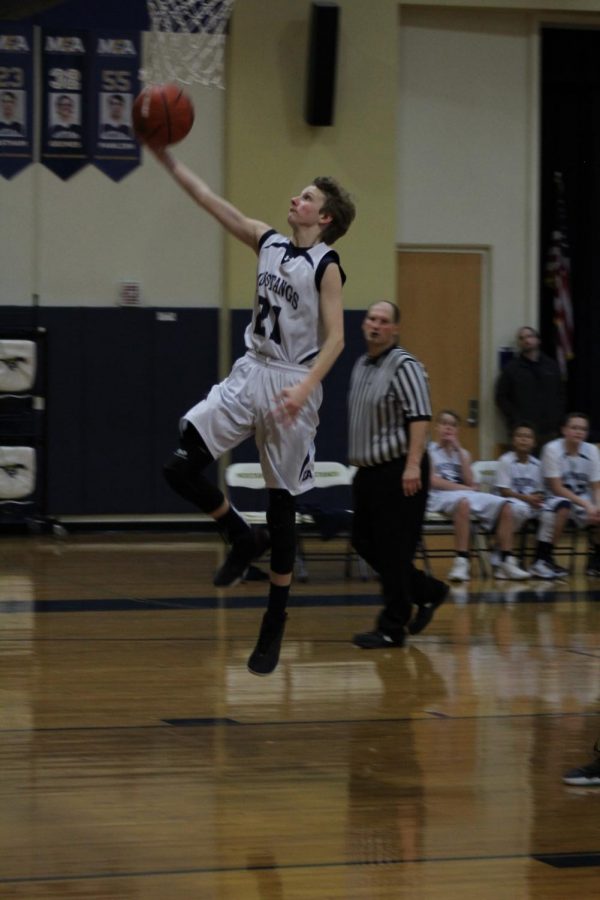 Eighth grader Adam Gerdes fast breaks down the court and scores two points off of a layup. 