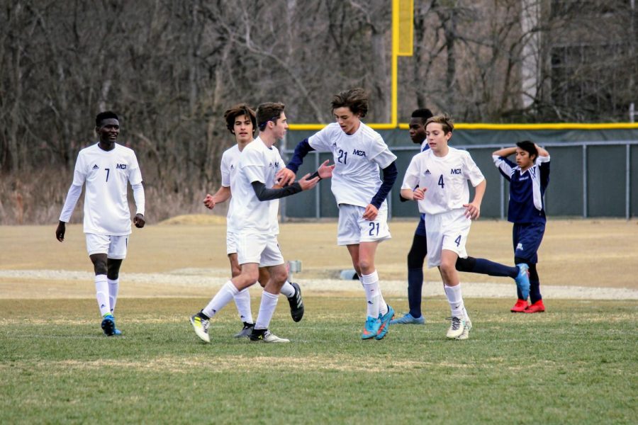 The Mustangs cheer after the ball was put into the back of the net. 