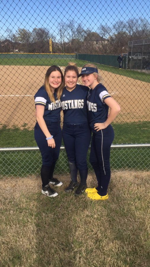 Juniors Kara Vita, Elizabeth Krusing, and Scout Mayberry pose for a picture after their district game.