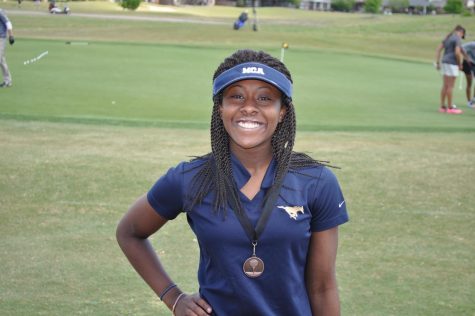 Freshman Morgan McGee poses for a picture with her medal for advancing to State.