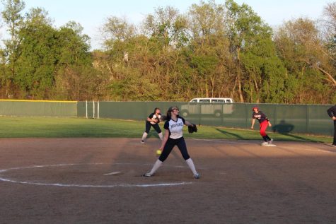 Sophomore Jodee Newland throws a fast pitch to the opposing team to strike the batter out.