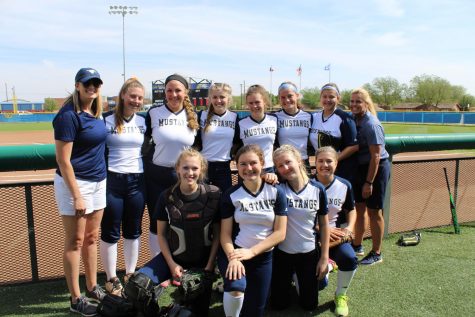 The Lady Mustang Softball team poses for one last picture in Lubbock.