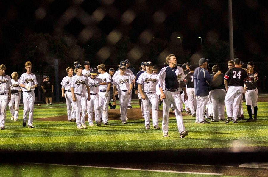 The Varsity Baseball team walks off the field after their last game of the season.