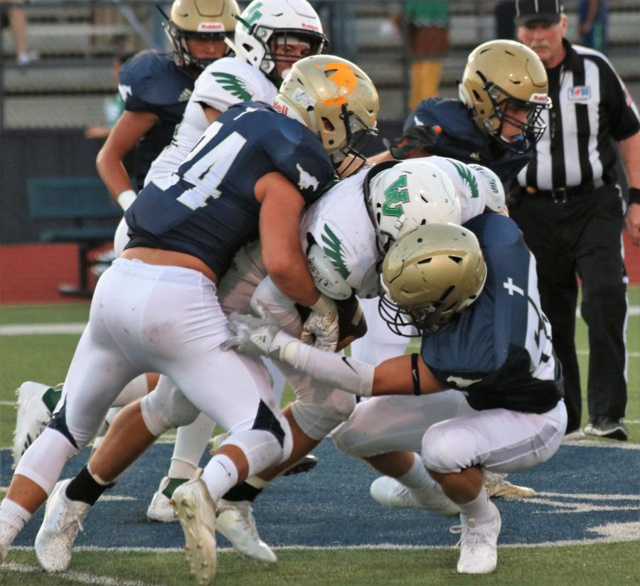 Senior Captain Rex Collins wraps up a tackle to end a run.