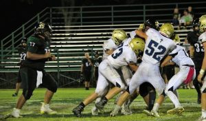 Senior Captain Caleb Doyle  leads a group of Mustangs in a tackle.