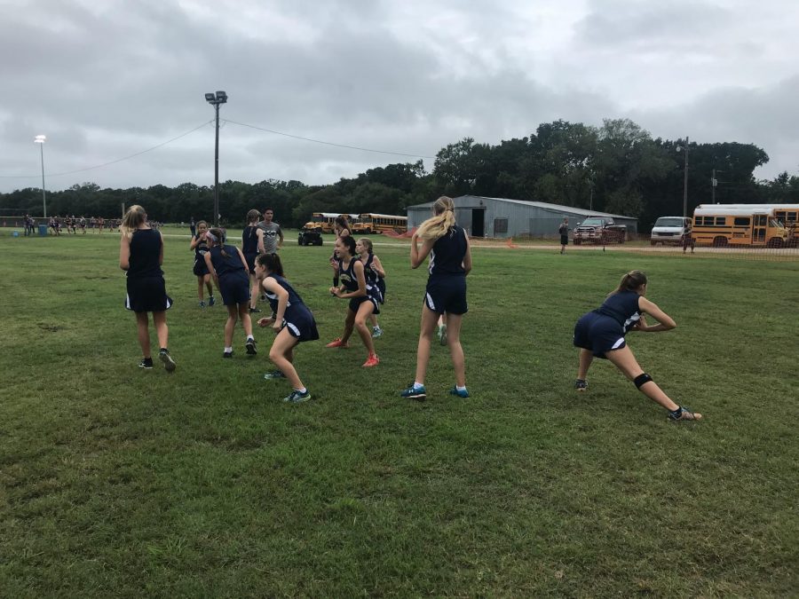 A few Cross Country girls warm up before their first race of the season at Sadler, it was quite muddy so the runners had to be extra prepared physically.
