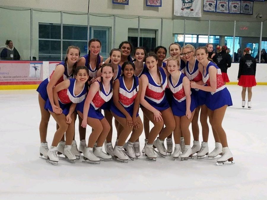 Senior Sarah Mayberry pictured far right takes a picture with her team after a competition 