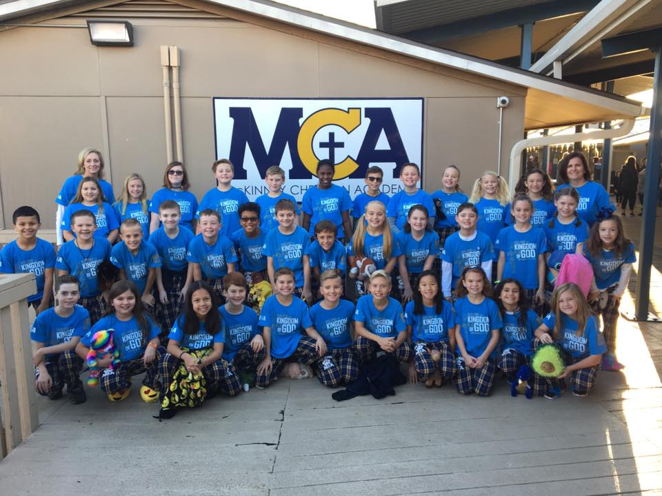 The 5th grade BigDogz pose for a class picture after parading down the deck on Pajama Day.