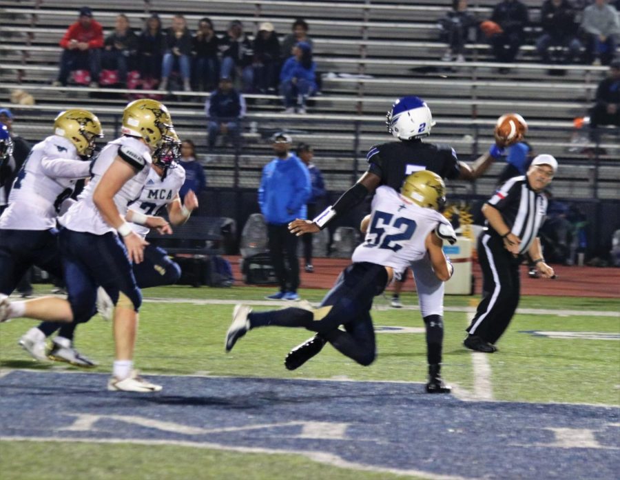 Senior Captain Caleb Doyle wraps up a tackle on Trinity  Christians quarterback.