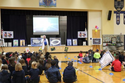 Lower School principal, Chris Hydock, tells his students about the BoosterThon Run in chapel.