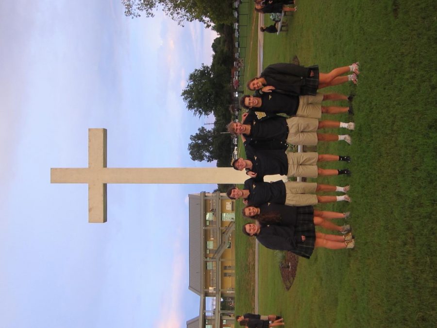 Seniors  Kara Vita, Emma Lowes, Mason Lee, Hayden Clow, Sam Utzig, Graham Kraft, and Elyse Mead stand in front of the cross after listening to Pastor Treys message 