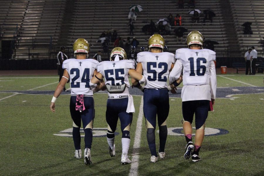 Varsity football players left to right. Rex Collins #24 (left) Graham Kraft #55, Caleb Doyle #52, Will Baxter #16(right)