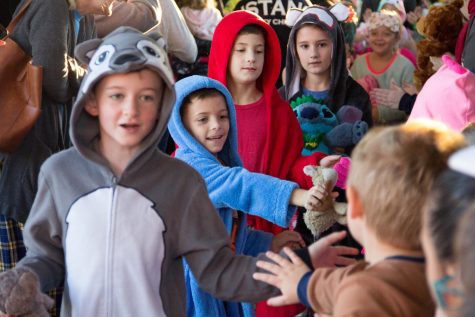 A few third graders march down the deck, greeting their friends with energetic hugs and high-fives.