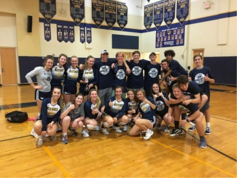Varsity volleyball celebrates a big win with the Late Night Spirit Squad in their new t-shirts.