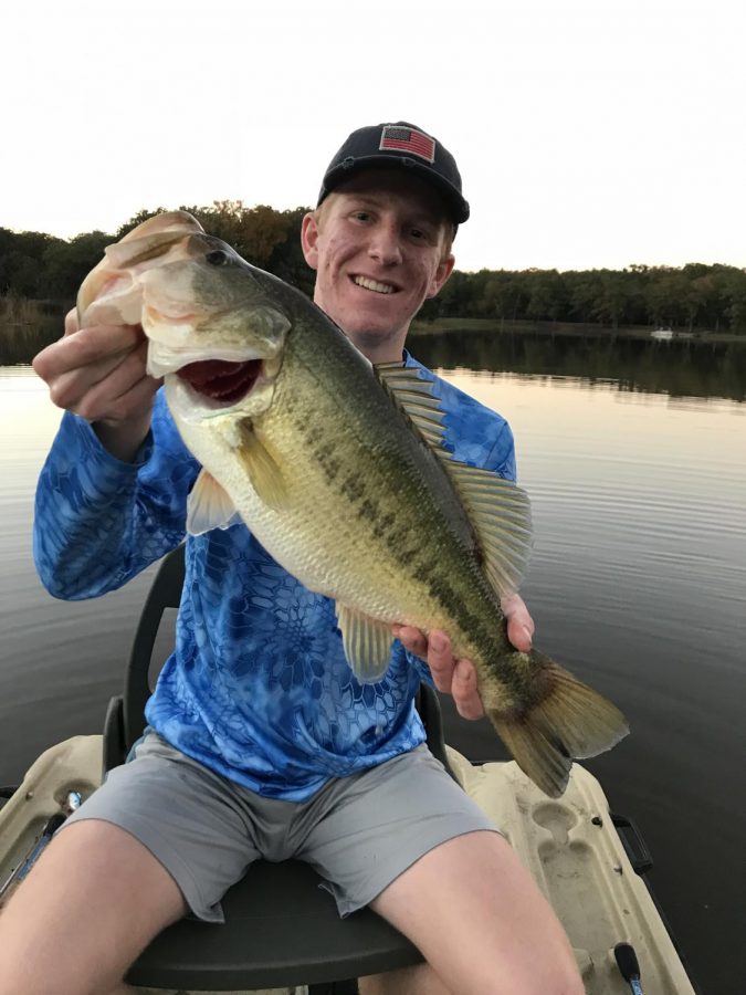 Junior Jason Cross holds up a big largemouth bass he caught at a local pond. Its very exciting to catch such a quality fish, because it doesnt happen too often.