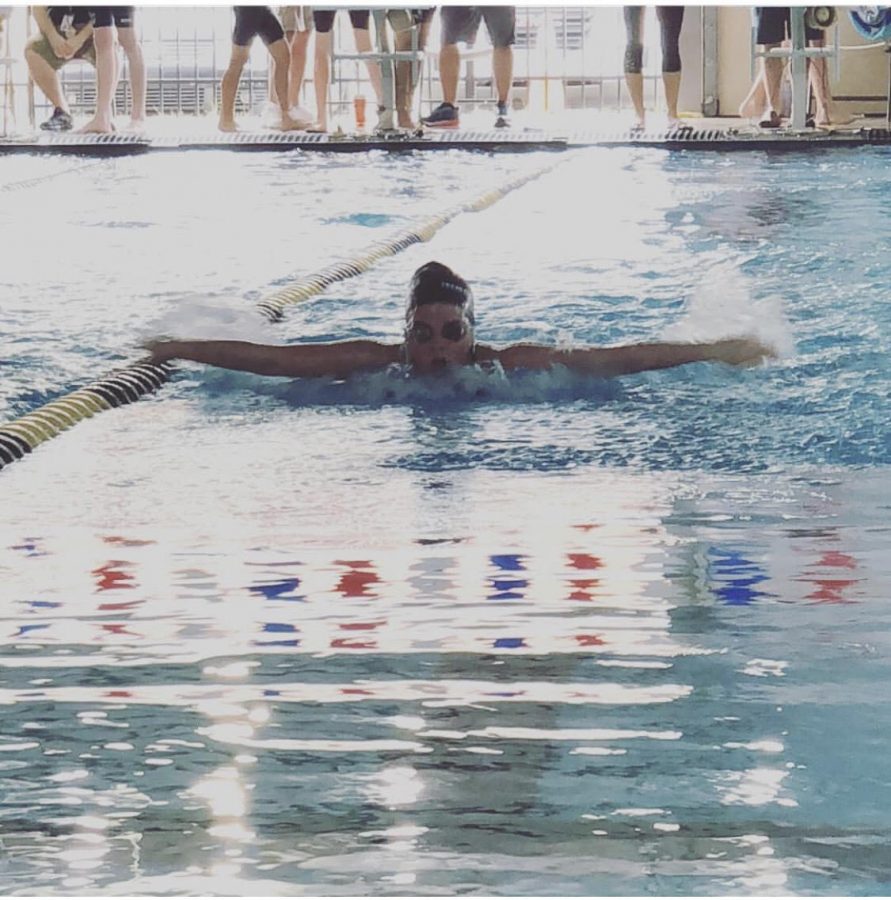 Freshman Peyton Baker competes in the butterfly race. 