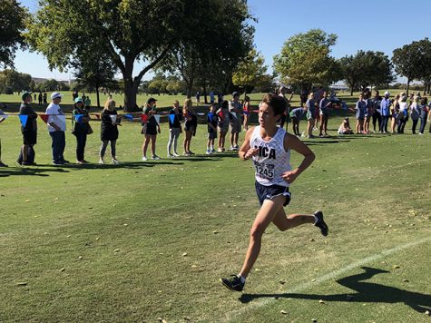 About 200 meters before the finish line, senior Riley Pyle kicks it in, giving the last stretch his all.