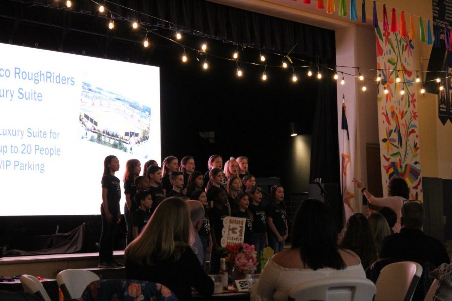 The Lower School Honor Choir sings for entertainment at the fiesta. 