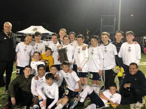 After they played hard, the middle school boys were still able to give a smile while holding their trophy with pride.