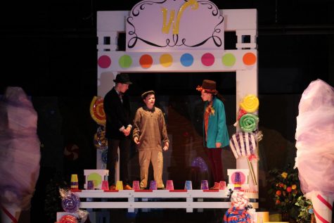 Willy Wonka talks to Charlie and Mr. Bucket
