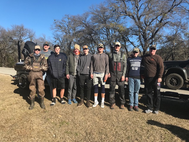 The fishing team poses for a picture after a day of fishing.