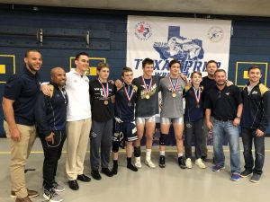 The MCA wrestlers that placed top three at PREP State and the coaches pose for a photo showing off their medals.