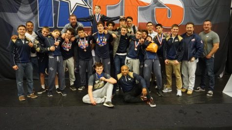 The Mustang wrestlers pose for a photo after getting fourth place at TAPPS State.