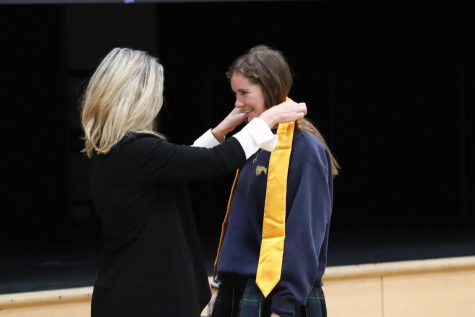 Juliana Roller accepts her NHS stole from Mrs. Smith during the induction ceremony.