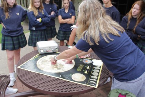 Boese explains to students which parts of the moon the samples were collected from.