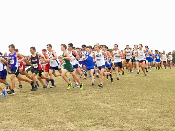 A pack of MCA runners can be seen cautiously rounding the first corner of the course. Runners were closely packed together for the first quarter-mile of the race.