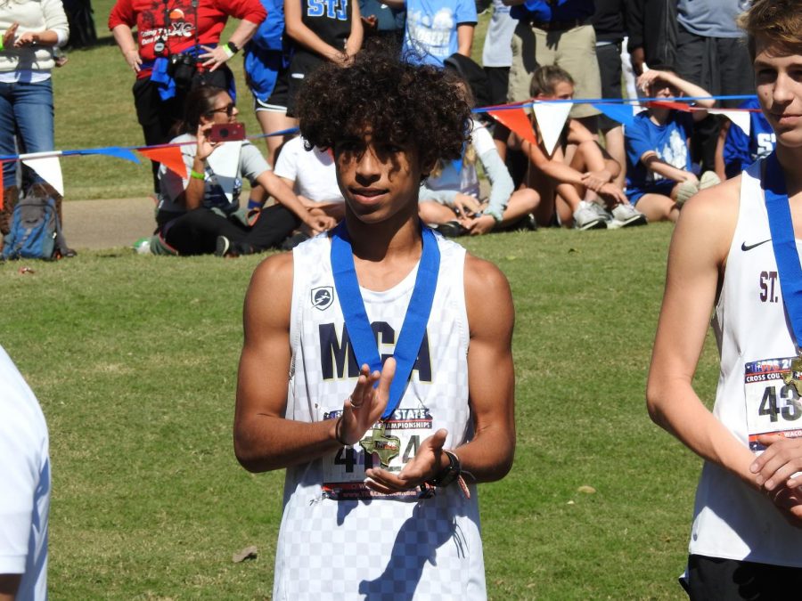 Junior, Maliq Brock after receiving the third place medal at the TAPPS cross country meet. 