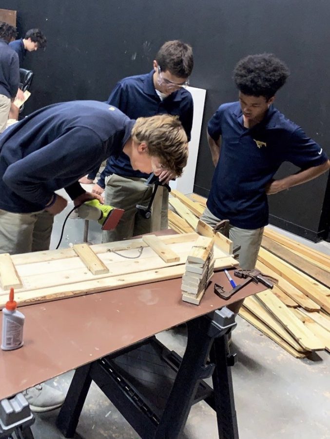 Theatre tech students constructing a desk for the one-act play.