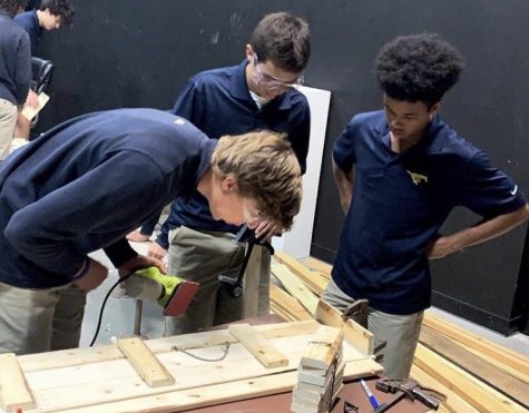 Theatre tech students constructing a desk for the one-act play.
