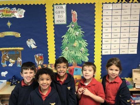 A group of Mrs. Stewart's kindergarten students take a picture in front of their