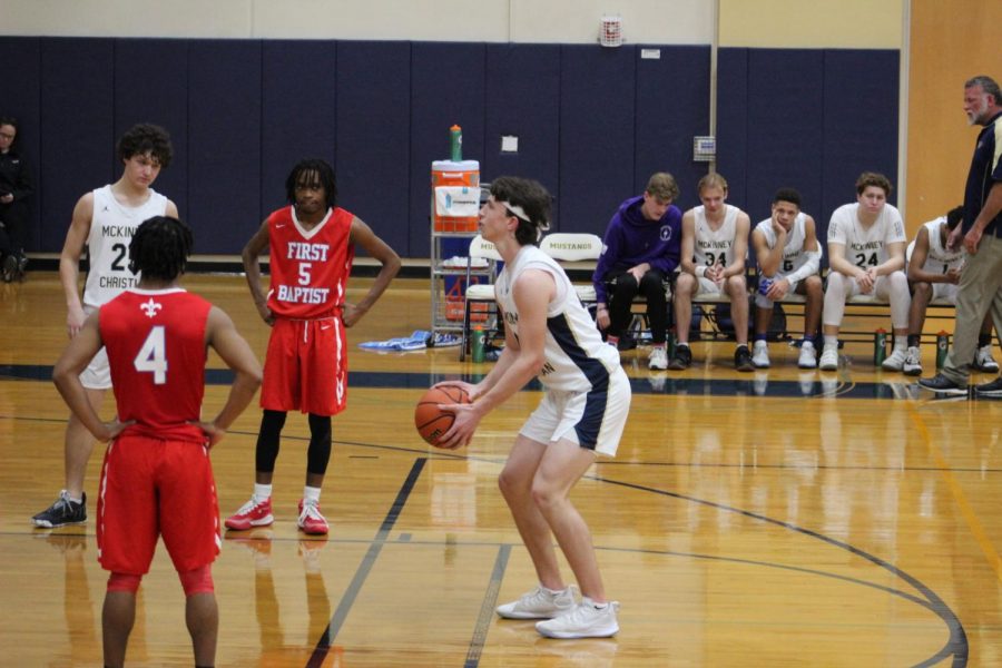 Junior Blake McGraw heads to the line to shoot two during the second half of the basketball game against First Baptist. 