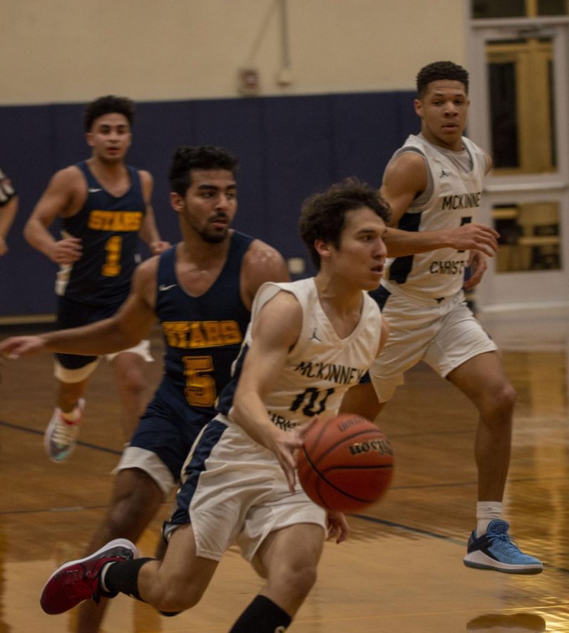 Senior Mark Voelkel dribbles down the court during a fast break.