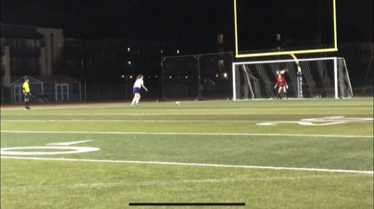 After a long fought game, Emma Bryant stares down the goalie as she attempts to score her PK.