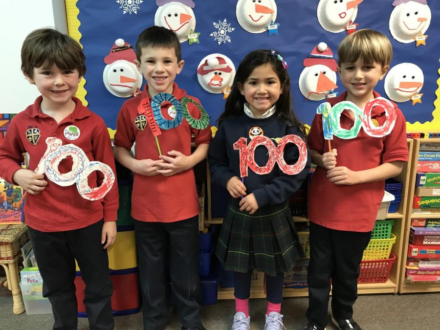 Kindergarteners Jaxen Judah,Hawkins Bound, Amelia Dominguez and Chase Neuner hold up their special 100 day glasses that they made.
